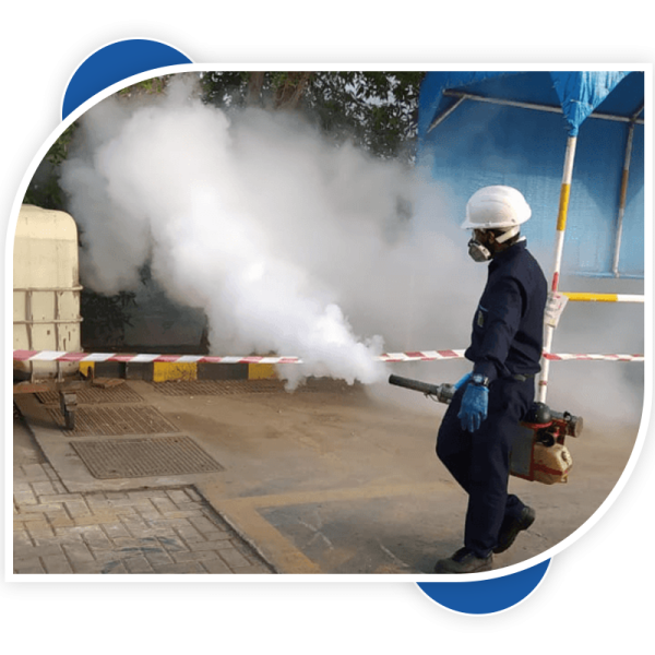 man holding the fumigation tank and spraying uncover areas.