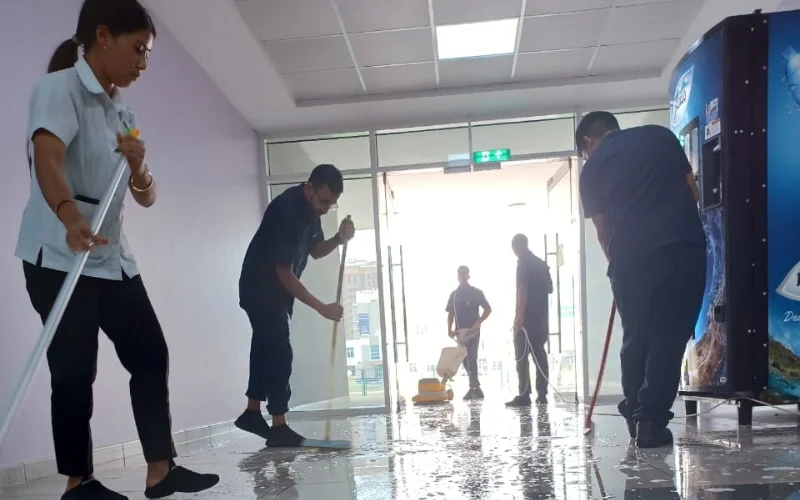 group of cleaners are cleaning the floor