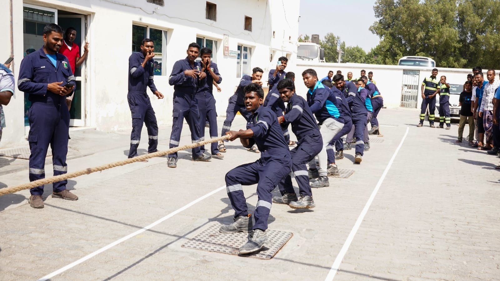 Employees competing in the Blue Diamond Group Tug of War team-building activity at Sonapur Camp.