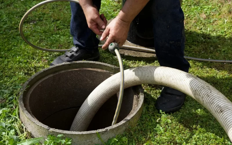 a man cleaning the sewage tank